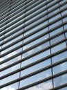 modern architecture abstract with geometric the sky reflected in slanted blue glass windows Royalty Free Stock Photo