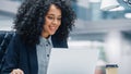 Modern Office: Black Businesswoman Sitting at Her Desk Working on a Laptop Computer. Smiling Succe Royalty Free Stock Photo