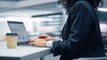 Modern Office: Black Businesswoman Sitting at Her Desk Working on a Laptop Computer. Successful Af Royalty Free Stock Photo