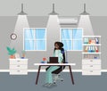 Modern office with black businesswoman sitting