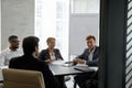 Young and middle-aged businesspeople take part in group meeting Royalty Free Stock Photo