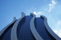 Modern office building against the blue sky. Wavy curved lines. City. Low angle. Royalty Free Stock Photo