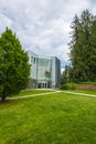 Modern office building with concrete pathways in front and trees around Royalty Free Stock Photo