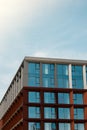 Modern office building exterior with glass facade on clear sky background. Transparent glass wall of office building Royalty Free Stock Photo