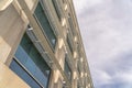 Modern office building exterior viewed against cloudy sky on a sunny day