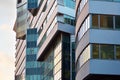 Modern office building facade abstract fragment, shiny windows in steel structure.