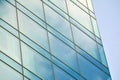 Modern office building facade abstract fragment, shiny windows in steel structure.