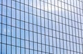 Modern office building facade. glass wall reflecting blue sky.