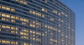 Modern Office Building Facade with Illuminated Windows at Dusk architecture lights Royalty Free Stock Photo