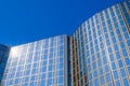 Modern office building with glass facade in front of blue sky Royalty Free Stock Photo