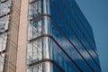 Modern office building glass facade with sky reflection in the windows of a skyscraper low angle view. Skyscrapers Royalty Free Stock Photo