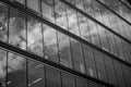 Modern office building glass facade, sky reflection in windows. Skyscrapers urban skyline. Architectural details. High Royalty Free Stock Photo