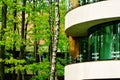 View of contemporary glass building with green trees Royalty Free Stock Photo