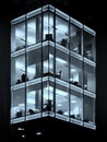 modern office building illuminated at night blue geometric windows Royalty Free Stock Photo