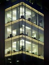 Modern office building illuminated at night with geometric windows Royalty Free Stock Photo