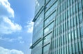 Modern office building with reflection of blue sky and clouds on its windows Royalty Free Stock Photo