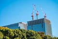 Modern office building under crane construction against blue sky Royalty Free Stock Photo