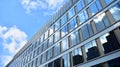 Office building, blue glass wall reflection detail. Modern office building and clear sky background. Royalty Free Stock Photo