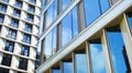 Office building, blue glass wall reflection detail. Modern office building and clear sky background. Royalty Free Stock Photo