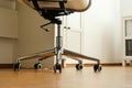 Modern office chair near table indoors. Stylish workplace interior