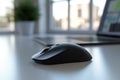 In a modern office, a clean desk holds a black wireless mouse, a laptop, and a keyboard Royalty Free Stock Photo