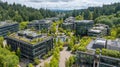 Modern Office Complex Surrounded by Greenery in a Tranquil Setting With a Pond and Lush Trees Royalty Free Stock Photo