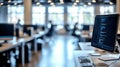 Modern office with computer screen displaying code in a collaborative workspace Royalty Free Stock Photo