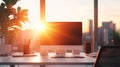 Modern office desk with computer during sunset Royalty Free Stock Photo