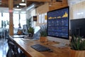 Modern Office Desk With Desktop Computer Displaying Data Charts and Graphs Royalty Free Stock Photo