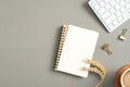 Modern office desk table with notepad, blank paper note, coffee cup, pc keyboard, stationery on green background. Autumn style