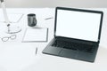 Modern office desktop with empty laptop screen