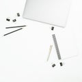 Modern office desktop workspace with laptop, notebook and accessories on white background. Top view. Flat lay. Royalty Free Stock Photo