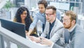 In Modern Office: Diverse Team of Businessmen and Businesswoman Work on Computer, Having Discussio