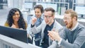 In Modern Office: Diverse Team of Businessmen and Businesswoman Work on Computer, Having Discussio