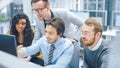 In Modern Office: Diverse Team of Businessmen and Businesswoman Work on Computer, Having Discussio