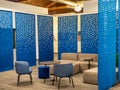 Modern office environment with some felt blue dividers and lounging couches and chairs Royalty Free Stock Photo