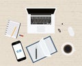 Modern office or freelancer workplace with laptop,notebook, coffee, pen, smartphone and mouse . Wood background. Top