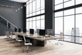 Modern office hall interior design with stylish wheel chairs around big conference wooden table with computers on parquet floor, Royalty Free Stock Photo