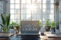 A modern office is illuminated by sunlight through large windows, featuring a laptop displaying data analysis charts and Royalty Free Stock Photo