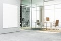 Modern office interior with a blank white poster mockup on the wall, glass partitions, and city view background for advertising Royalty Free Stock Photo