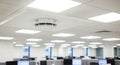 Modern office interior with bright fluorescent ceiling lights and computer workstations Royalty Free Stock Photo