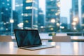 Modern office interior for business with a laptop at the workplace on a blurred metropolis background, stylish minimalist design