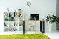 modern office interior with computer monitor on table and books with folders