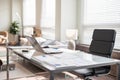 Modern office interior design with office chair and desk in front of windows. Workplace Royalty Free Stock Photo