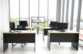 Modern office interior design with table, computer, monitor, big glass window around the room