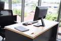 Modern office interior design with table, computer,  monitor, note book and big glass window around the room Royalty Free Stock Photo