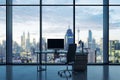 Modern office interior with empty computer monitor on desk and panoramic windows with beautiful city view and daylight. Mock up. Royalty Free Stock Photo