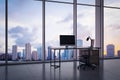 Modern office interior with empty computer screen on desk and panoramic windows with beautiful city view and daylight. Royalty Free Stock Photo