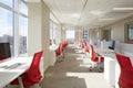 Modern office interior featuring bright, spacious layout with white desks and red chairs, showcasing a collaborative workspace Royalty Free Stock Photo