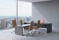Modern office interior with huge windows and New York panoramic view. Brown leather on the chairs and a black table. A concept of Royalty Free Stock Photo